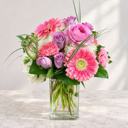 Pink and lavender bouquet in a clear glass vase