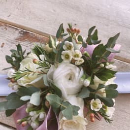 White rose bouquet with small white blossoms and a lavender ribbon