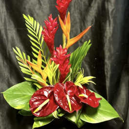 Tropical arrangement with red anthuriums and orange bird-of-paradise flowers
