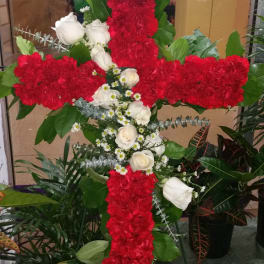 Red and white floral cross arrangement with roses