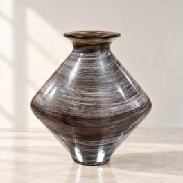 Brown striped glass vase on a light surface