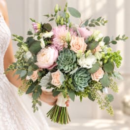 Bridal bouquet of blush roses, pink blooms, and succulents with eucalyptus