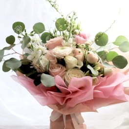 Pink and white rose bouquet with eucalyptus wrapped in pink paper