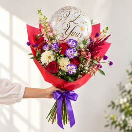 Handheld bouquet of mixed flowers with a "I Love You" balloon