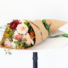 Wrapped bouquet of mixed flowers with roses and chrysanthemums
