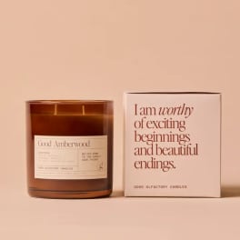Amber glass candle beside a matching box with printed text