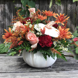 Pumpkin-shaped vase with orange and pink flowers