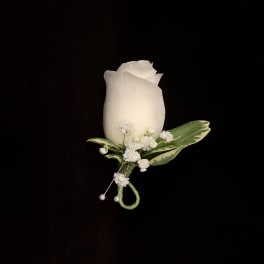 White rose boutonniere with small white accent flowers