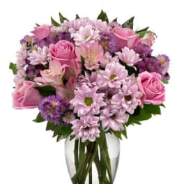 Pink and purple mixed bouquet in a clear glass vase