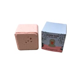 Pink bath fizzy beside its illustrated box