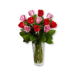 Bouquet of red and pink roses in a clear glass vase
