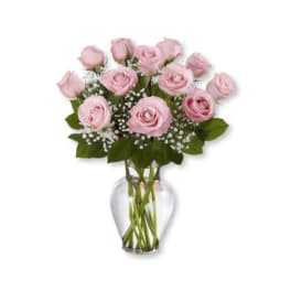 Pink roses arranged in a clear glass vase