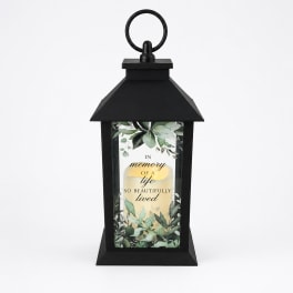 Black memorial lantern with a printed remembrance message and faux candle glow