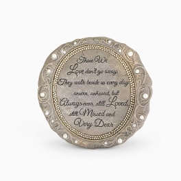 Round memorial plaque with a sympathy quote in an ornate frame