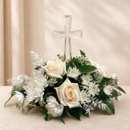 White rose and chrysanthemum arrangement with a clear cross centerpiece