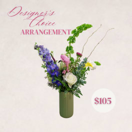 Tall mixed flower arrangement in a green vase with pink text and a price badge