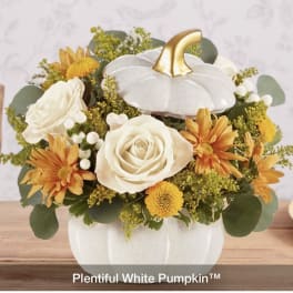 White pumpkin-shaped vase with white roses and yellow-orange flowers