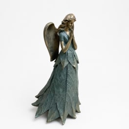Angel figurine with folded hands and leaf-like dress