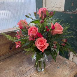 Pink roses and alstroemeria in a clear glass vase
