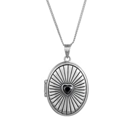 Silver locket necklace with a black heart center on a white background
