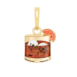 Gold-toned charm with skulls and a citrus slice accent