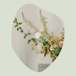 Loose floral arrangement with peach and white blooms in a vase