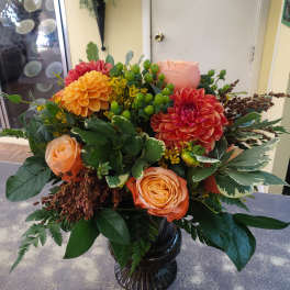 Orange and pink flower arrangement in a black vase