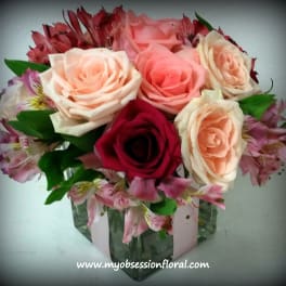 Bouquet of pink and peach roses in a glass vase
