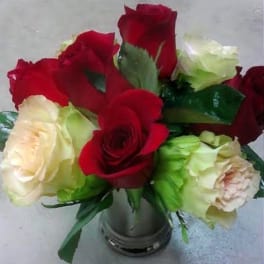Bouquet of red and cream roses in a metal vase