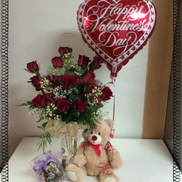 Red rose bouquet with a heart-shaped Valentine's balloon and teddy bear