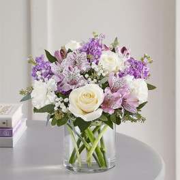 White and lavender bouquet in a clear glass vase