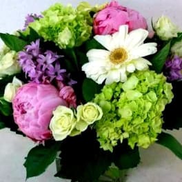 Bouquet of pink and green flowers with a white daisy