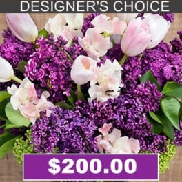 Purple and pink floral arrangement with tulips and orchids