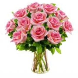 Pink roses arranged in a clear glass vase