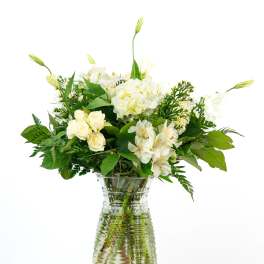 White flowers arranged in a clear glass vase