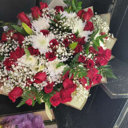 Bouquet of red roses and white chrysanthemums with baby's breath