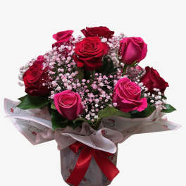 Bouquet of red and pink roses with baby's breath in wrapped paper