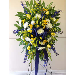 Tall standing floral spray with yellow, white, and blue flowers