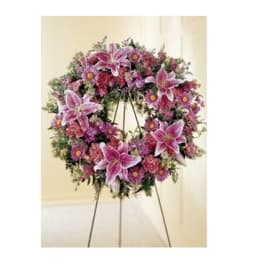 Pink and purple floral wreath on a stand