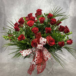 Red roses arranged with a heart-patterned ribbon