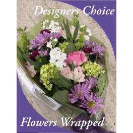 Wrapped bouquet of pink, purple, white, and green flowers