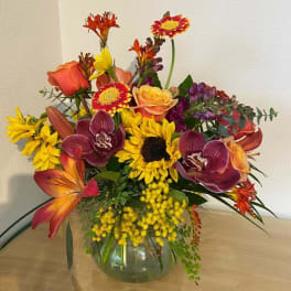 Mixed bouquet of bright flowers in a glass vase