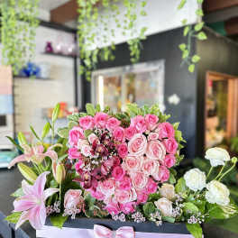 Pink rose arrangement with lilies in a rectangular box