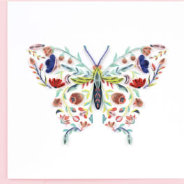 Colorful paper butterfly artwork on a white background