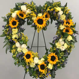 Heart-shaped floral wreath with sunflowers, white roses, and yellow blooms