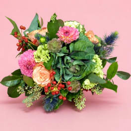 Mixed bouquet with pink and peach flowers on a pink background