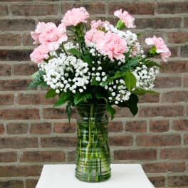 Pink carnations and white baby's breath in a glass vase