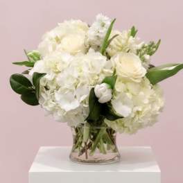 White floral bouquet in a clear glass vase