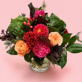 Pink and peach flower arrangement in a clear glass vase