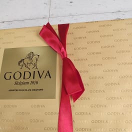 Godiva assorted chocolate gift box with a red ribbon